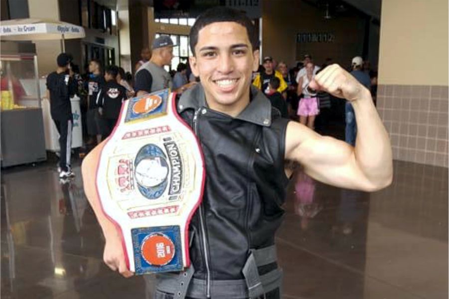 coach victor when younger holding boxing championship belt