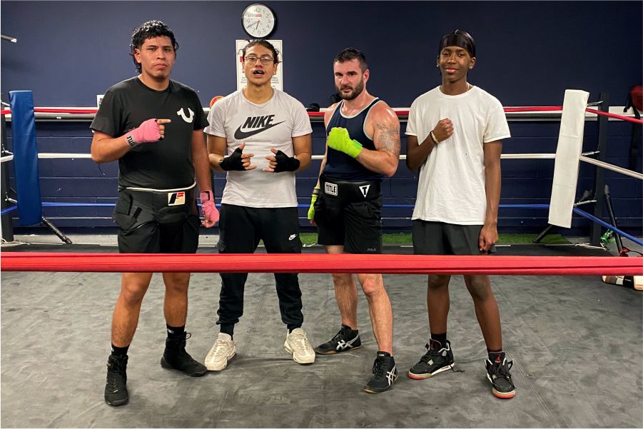 customers taking group photo after during boxing class