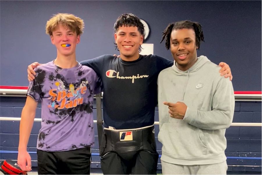 customers taking group photo after during boxing class
