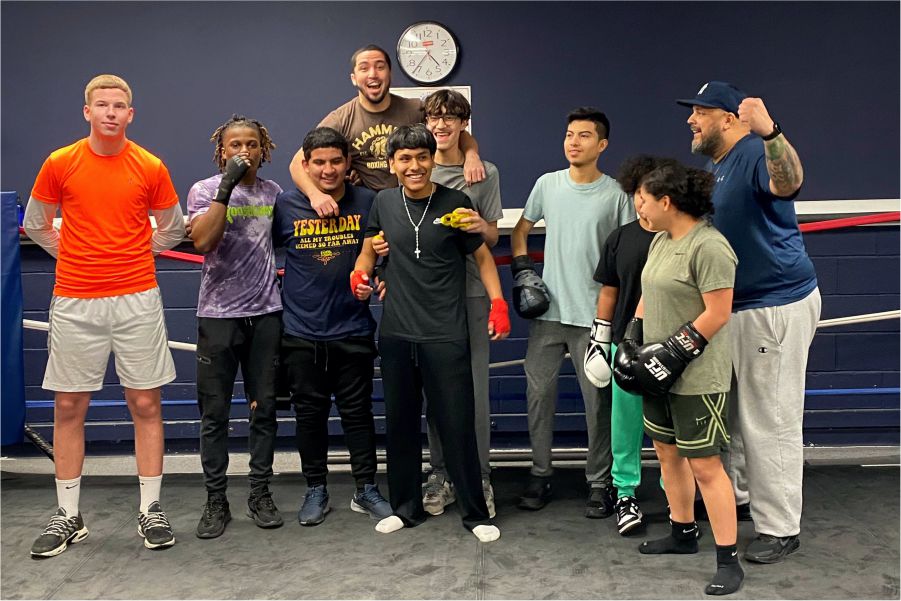 customers taking group photo after during boxing class