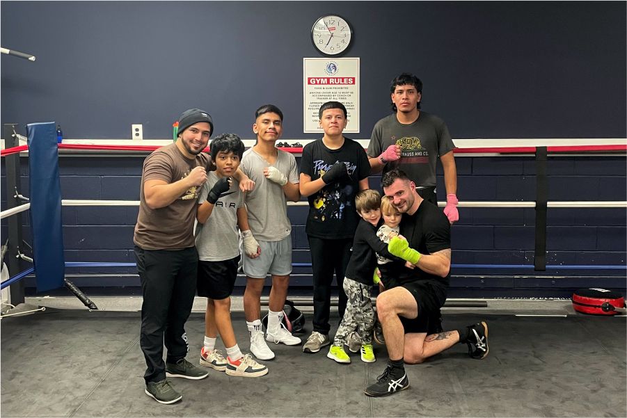 customers taking group photo after during boxing class